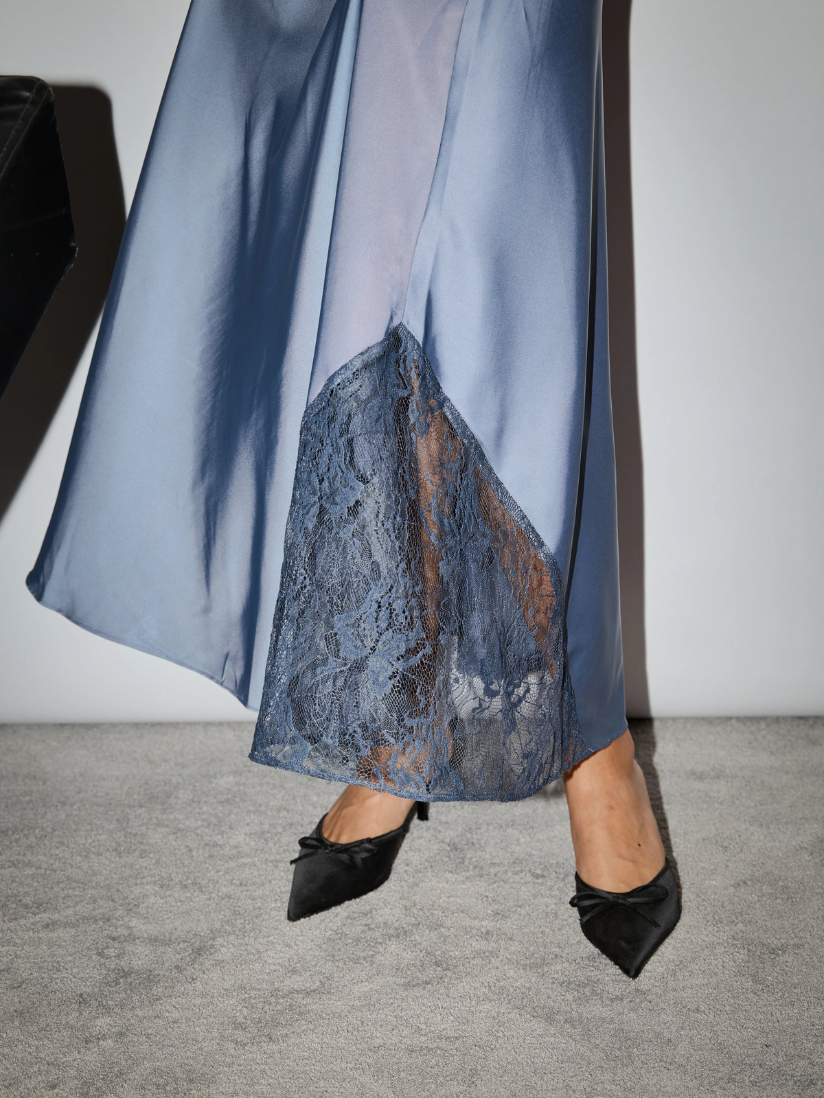 Close-up of embroidered hem on sapphire slip dress